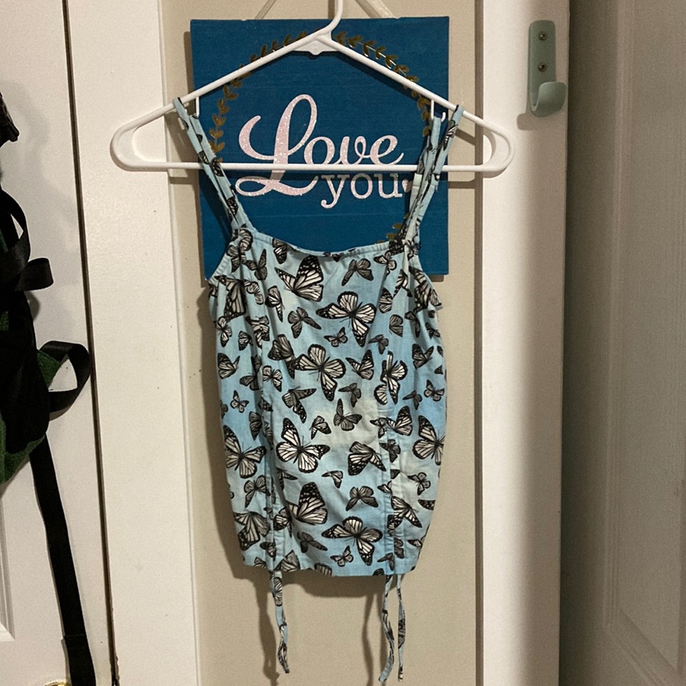 A blue tank top with black flowers size small